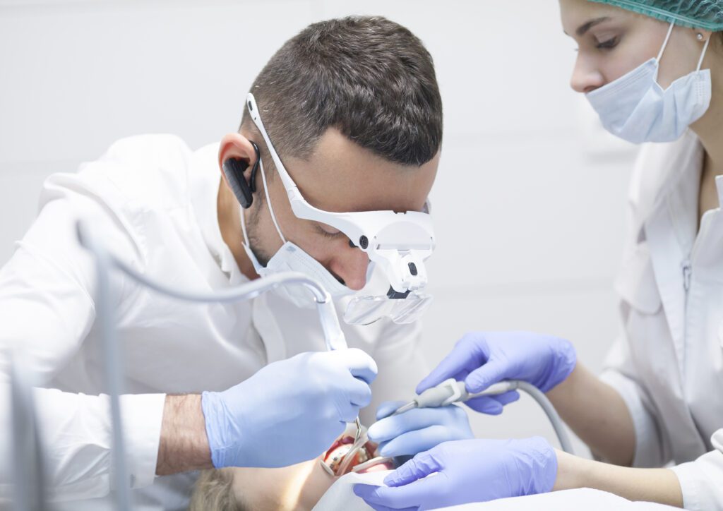 Dental cure. Molar treatment. Young female patient visiting dentist office.