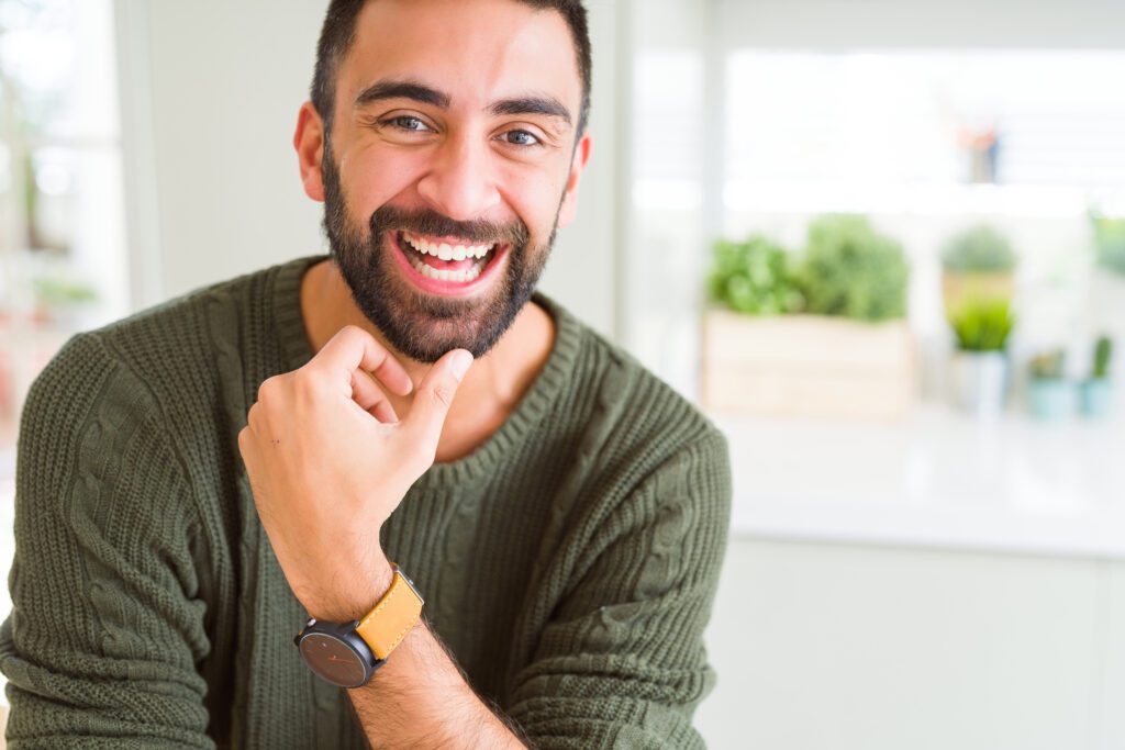 Handsome man smiling cheerful with a big smile on face showing t