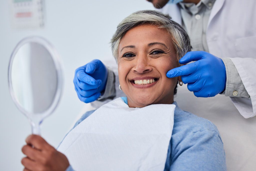Happy senior woman, teeth and dentist for dental care, appointment or checkup at clinic. Portrait of elderly female person smile for tooth whitening, cleaning or oral, mouth and gum care at hospital