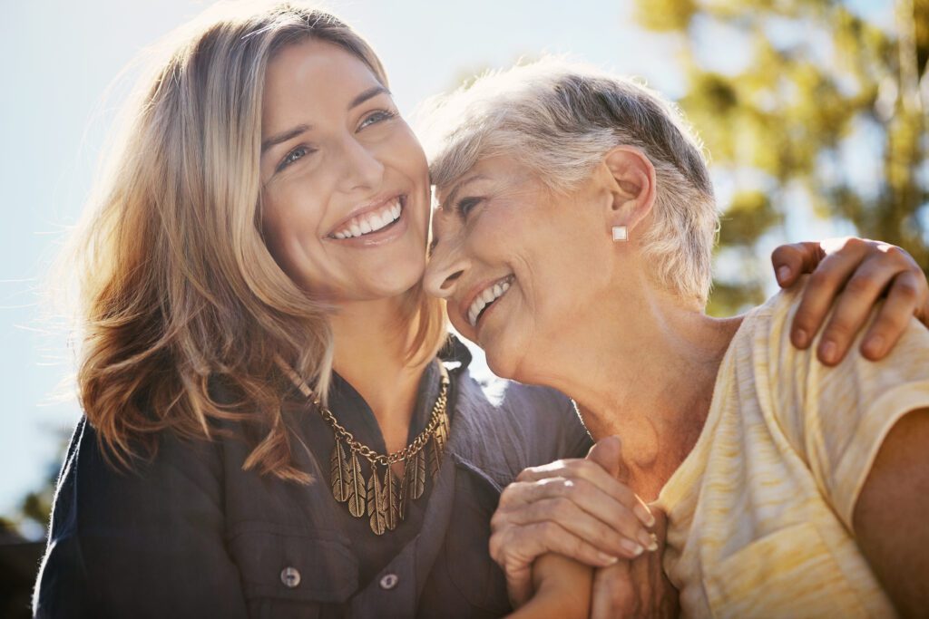 Senior mom, woman and hug for love, support care and happiness together in nature park. Elderly mother, happy family and daughter relax, calm and smile for relationship bonding adventure outdoor