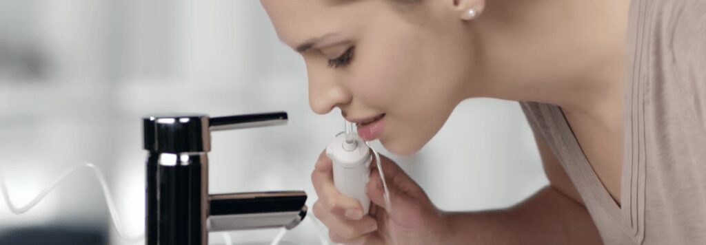 woman using waterpik
