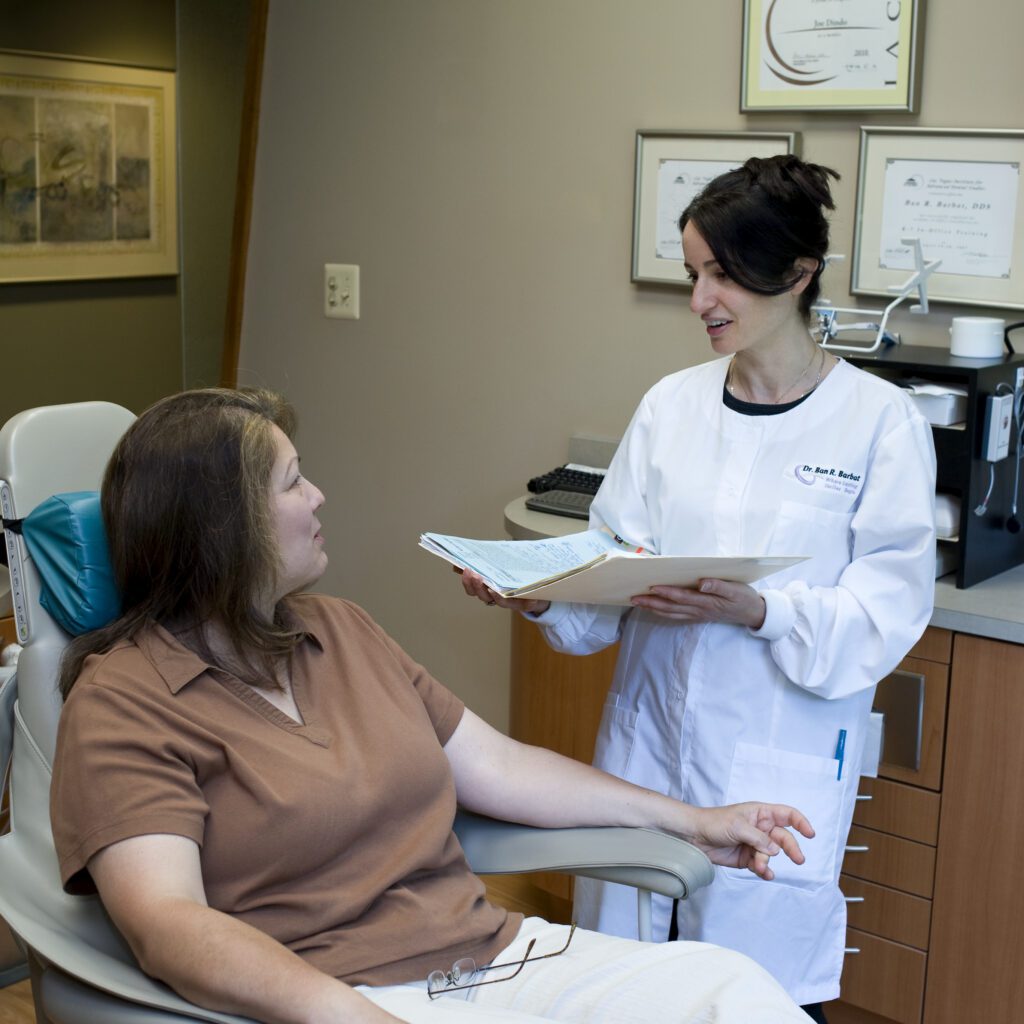 Dr. Barbat speaking with client